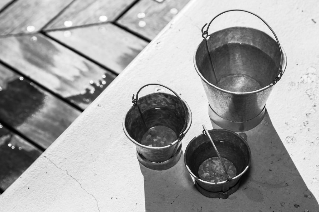 grayscale shot of different sizes of metal buckets 2023 11 27 05 05 12 utc